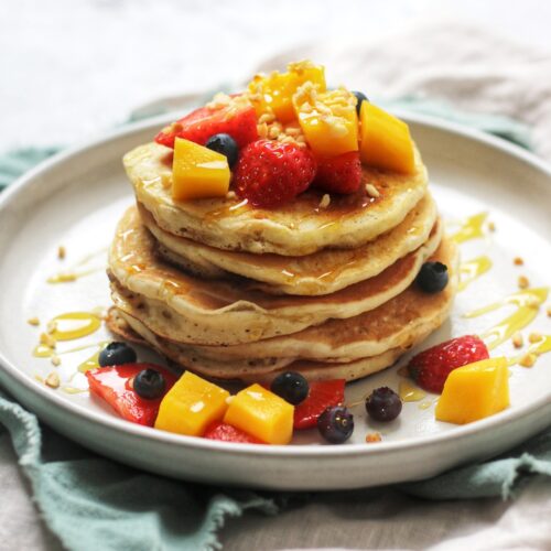 A Stack of American Style Pancakes topped with summer fruits