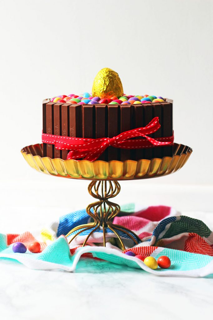 This over the top Chocolate Easter Cake is a real showstopped. Made with chocolate sponge, chocolate buttercream and covered in chocolate bars and candy it is a chocoholics dream. Get the recipe at Supper in the Suburbs!
