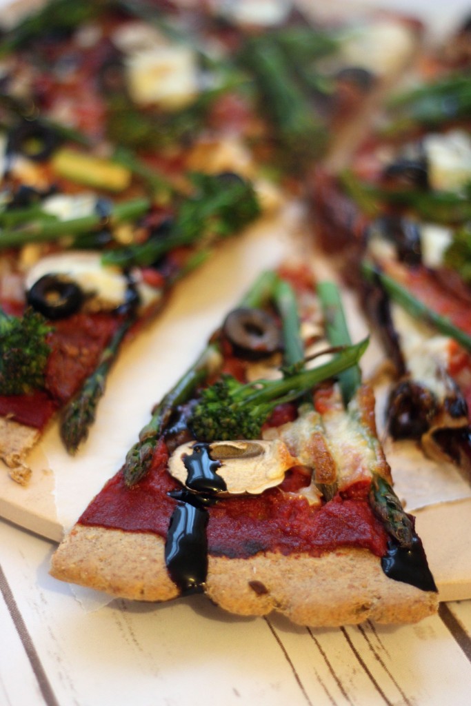 A slice of Broccoli and Asparagus Pizza with Balsamic Glaze