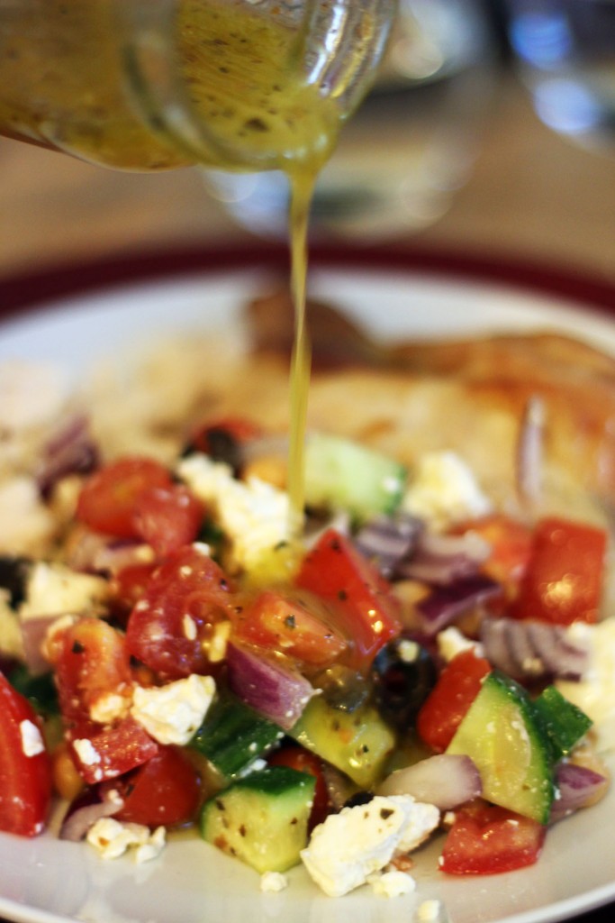 Greek vinaigrette served over chopped salad and herby chicken