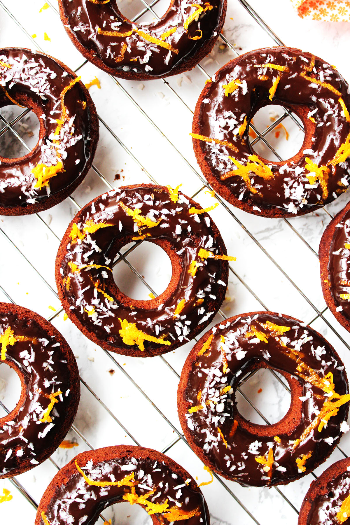 Baked Chocolate Orange and Coconut Doughnuts make a tasty afternoon snack, decadent breakfast or chocolatey treat just because. Get the recipe at Supper in the Suburbs