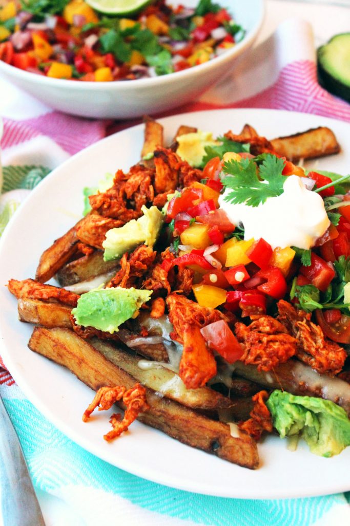 These Fully Loaded Nacho Fries have all the flavours of classic nachos with chilli, salsa, guacamole and sour cream, shredded spicy chicken and cheese but with chips instead of tortillas. This is one epic mid week meal, Saturday supper or sharing dish. Recipe at Supper in the Suburbs.