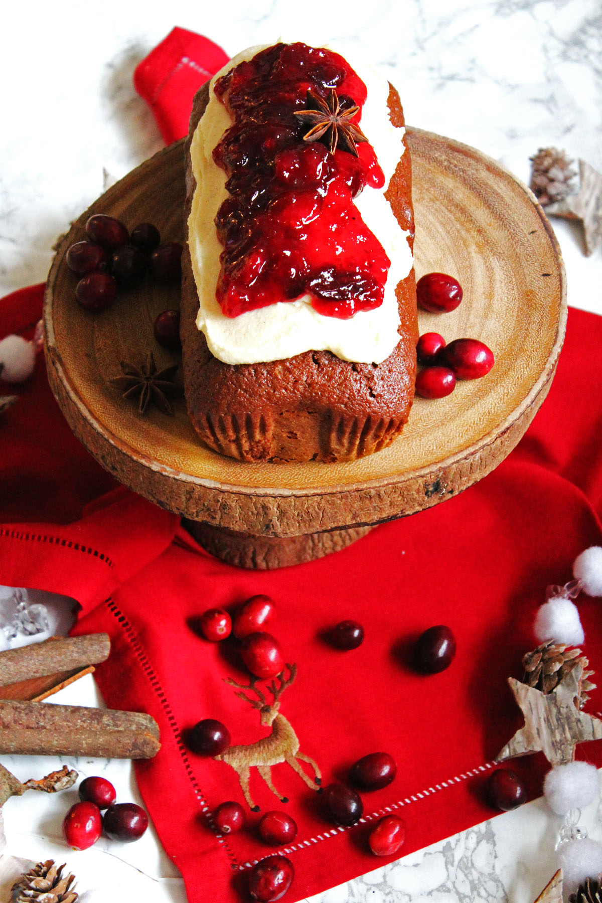 This Cinnamon Loaf Cake is topped with Cream Cheese Frosting and a Mulled Cranberry Compote. It's the perfect afternoon treat for the cold winter months. Why not serve with a hot cup of coffee on a frosty afternoon. Get the recipe for this simple loaf cake at Supper in the Suburbs