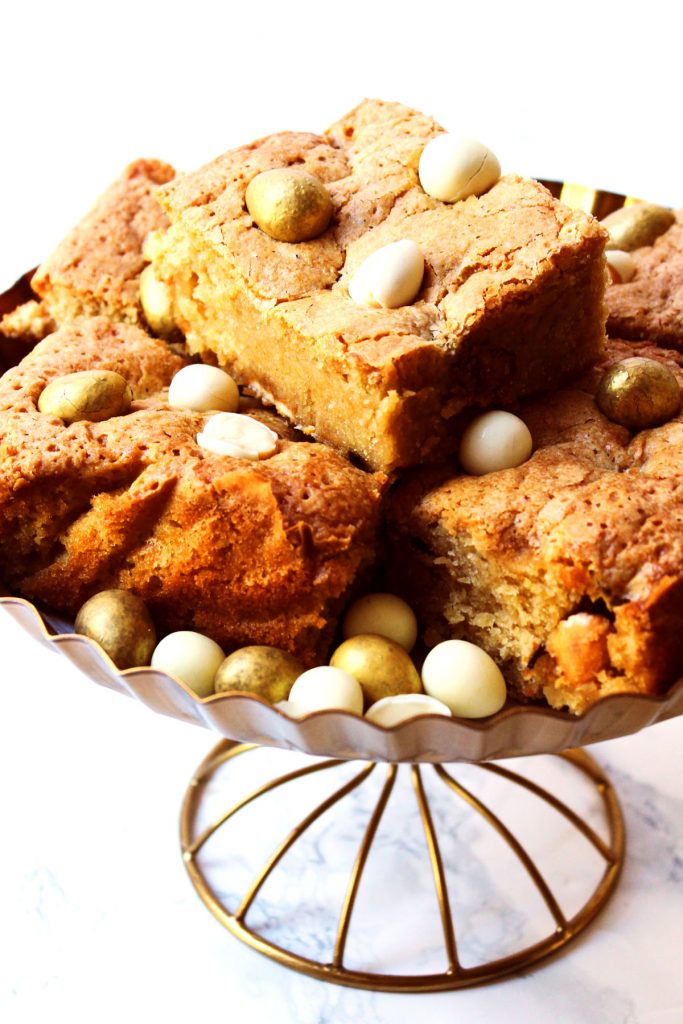 These Easter Blondies (aka White Chocolate Brownies) are the perfect Easter treat! Made with Galaxy's Golden Eggs and Milky Bar White Chocolate Mini Eggs. Get the recipe at Supper in the Suburbs!