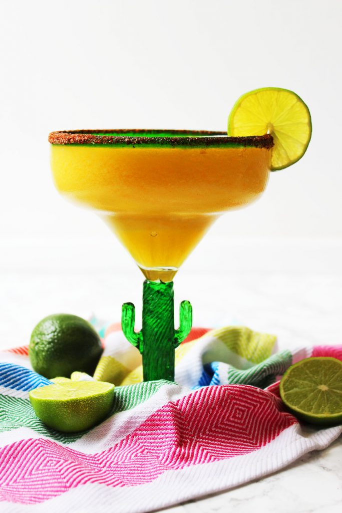 This Frozen Mango Margarita is a fun twist on the classic Mexican cocktail. Perfect for Cinco De Mayo or a hot summer day! Fiesta! Get the recipe at Supper in the Suburbs!
