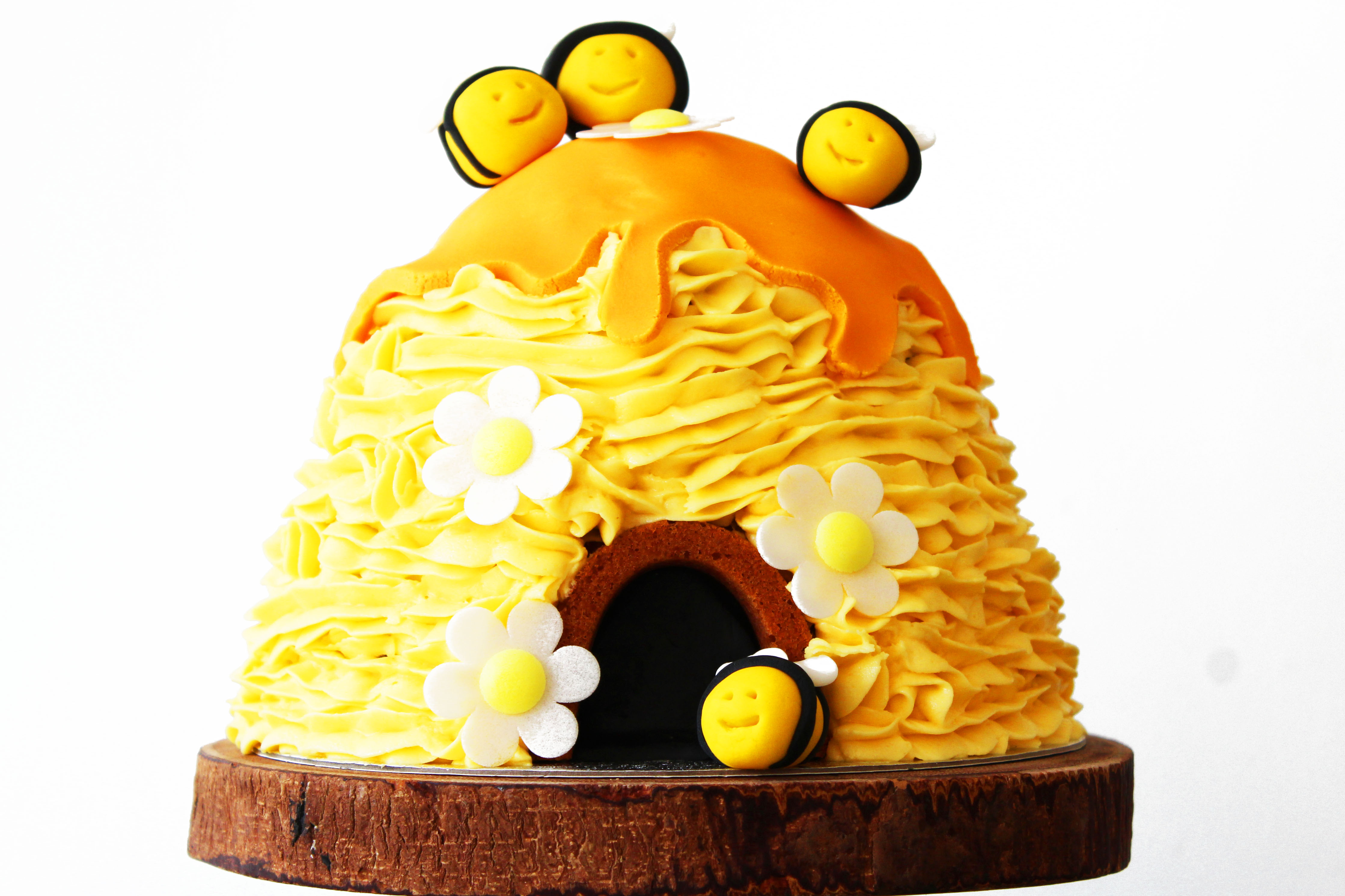 3D Beehive Cake with honey drips and buzzing bees