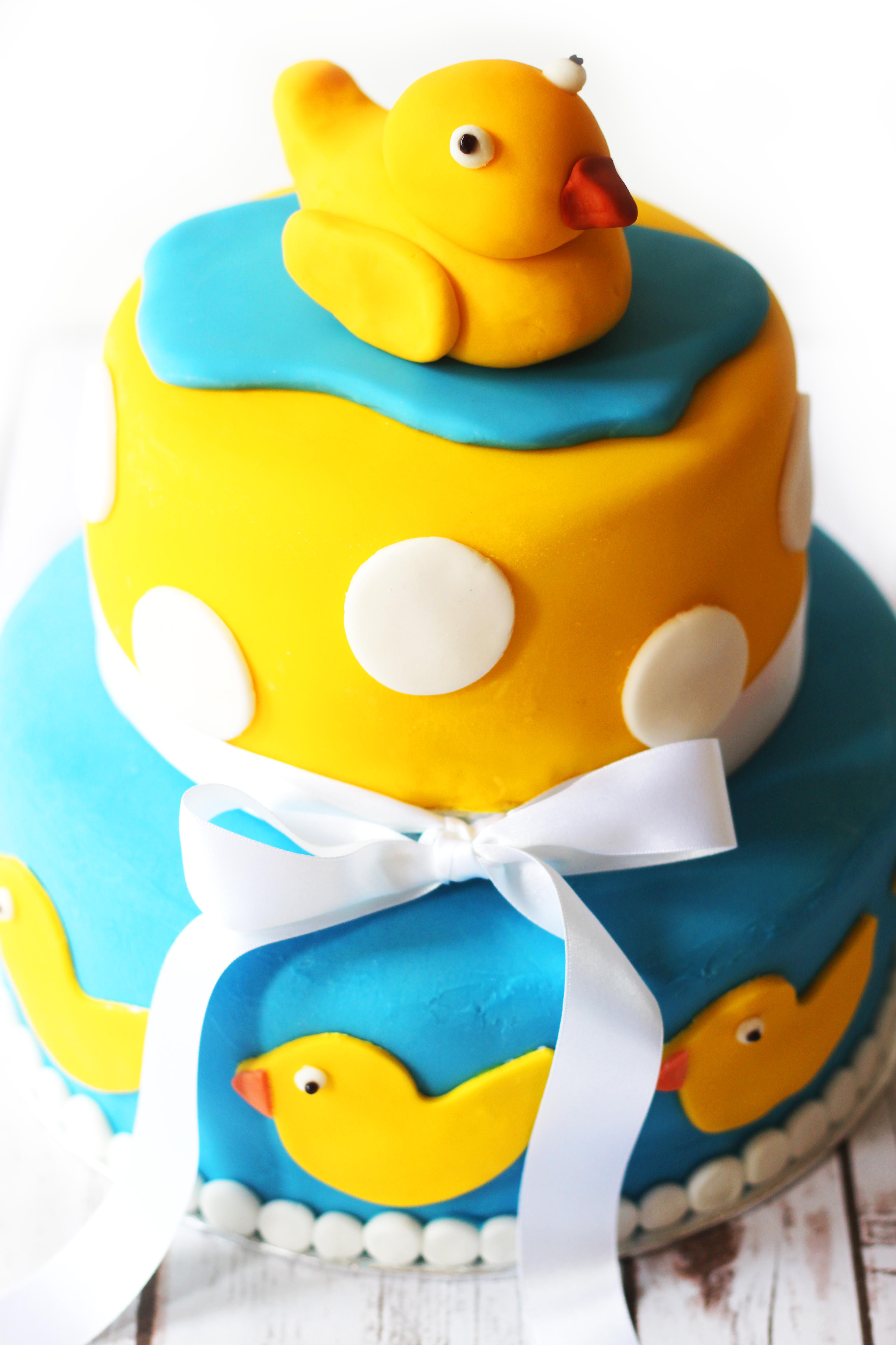 Two tier celebration cake, perfect for a baby shower complete with rubber duckies and polka dots!
