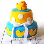This Two tier celebration cake, perfect for a baby shower complete with rubber duckies and polka dots!