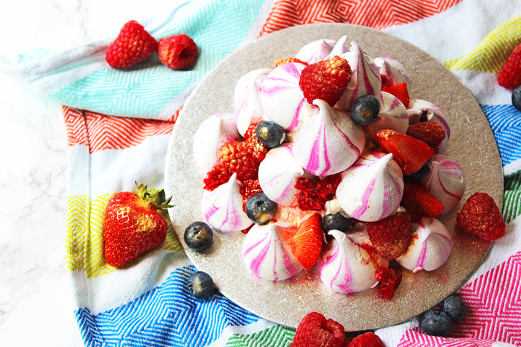 Eton Mess Stack made with meringue kisses, raspberries, strawberries, blueberries and whipped cream. Get the recipe at Supper in the Suburbs!