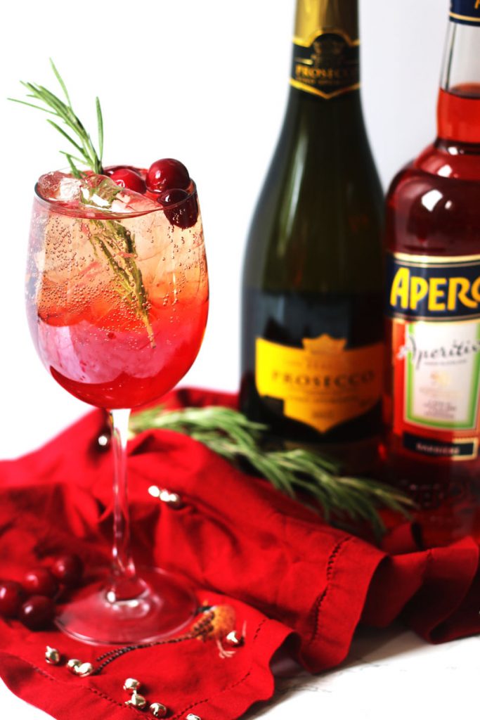 Cranberry and Aperol Sprtiz made with cranberry juice, aperol and prosecco.