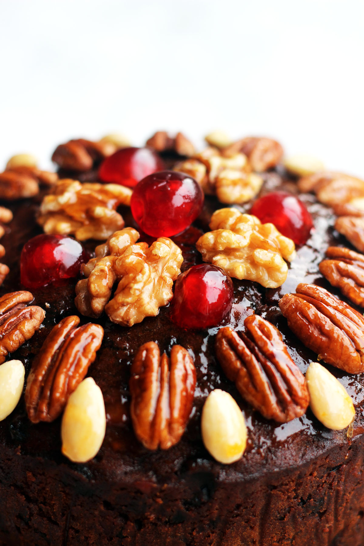 This Naked Christmas Cake looks like a decoration with glazed fruit and nuts on top. Get the recipe at Supper in the Suburbs!