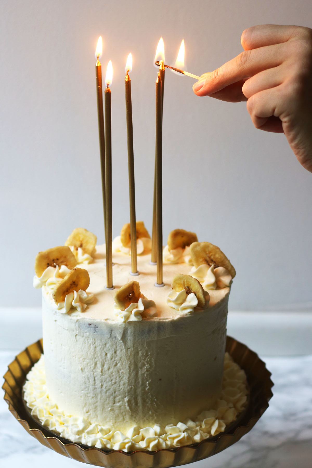 Lighting the candles on my Banana Cream Cake for my birthday