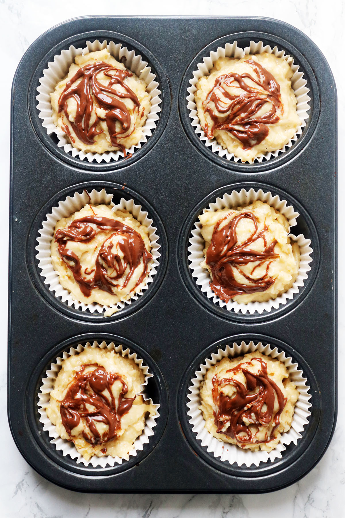 These Nutella Stuffed Muffins are the perfect way to celebrate Wolrd Nutella Day. Get the recipe at Supper in the Suburbs!