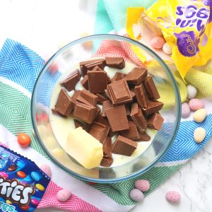 A microwave proof bowl with chocolate, butter and condensed milk