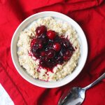 Aerial shot of a bowl of porridge topped with spiced berry compote