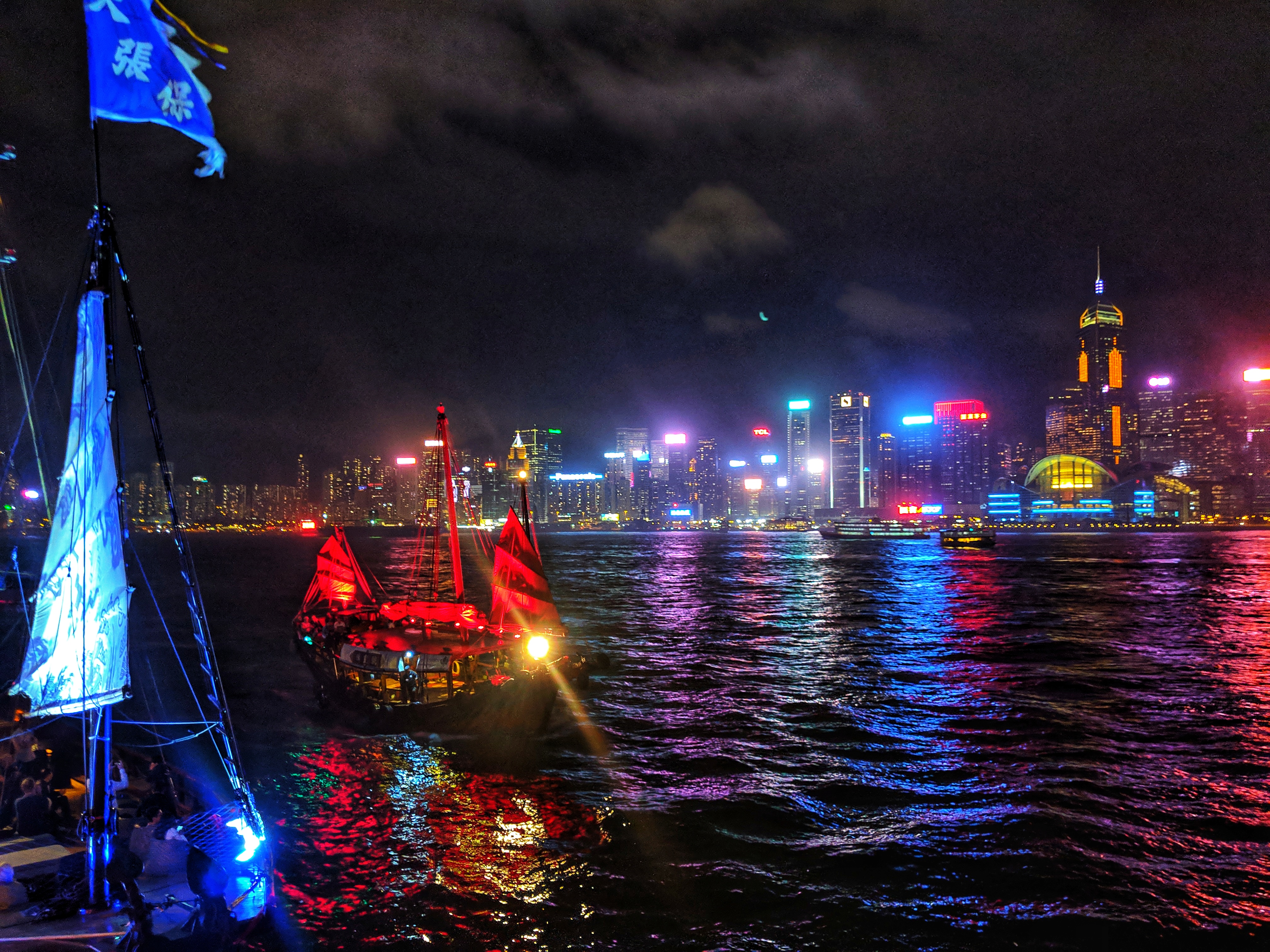 Traditional fishing boat in Victoria Bay, Hong Kong lit up at night