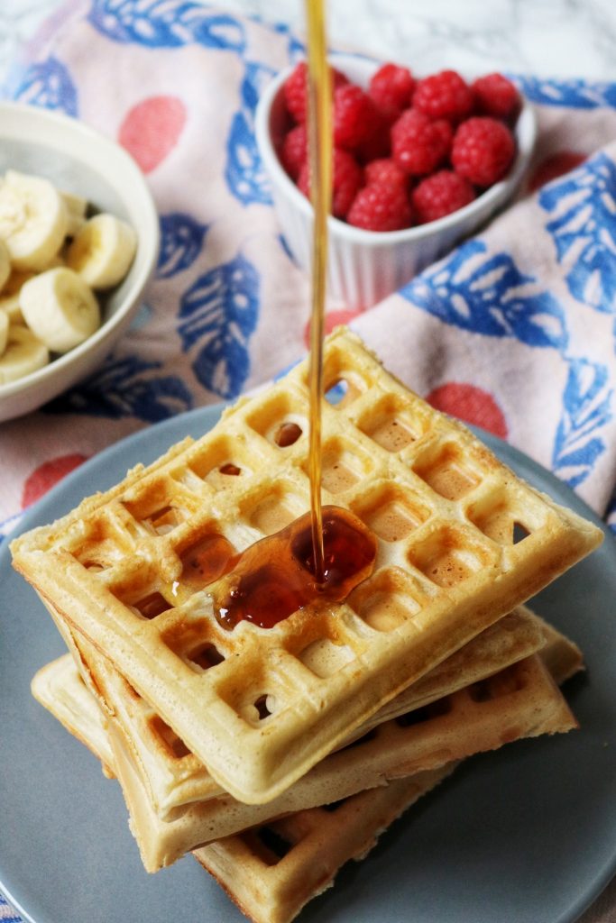 Sourdough waffles drizzled with maple syrup