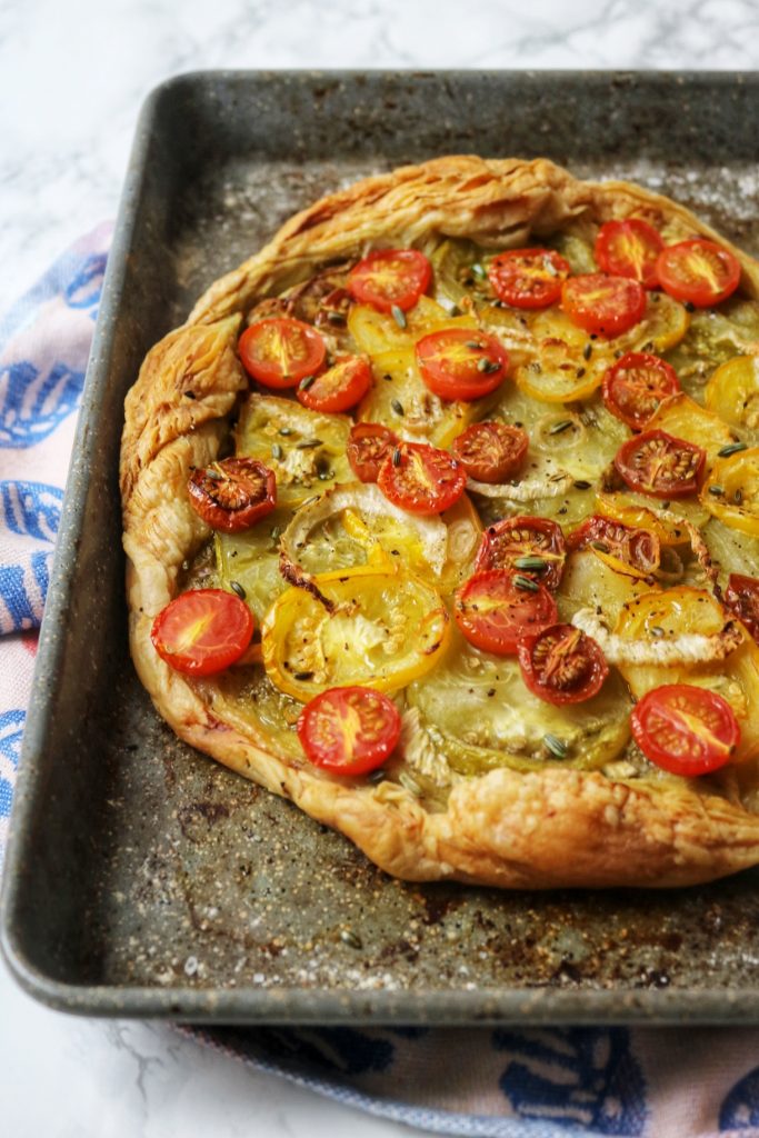 Up close shot of a tomato and fennel tart on a baking sheet