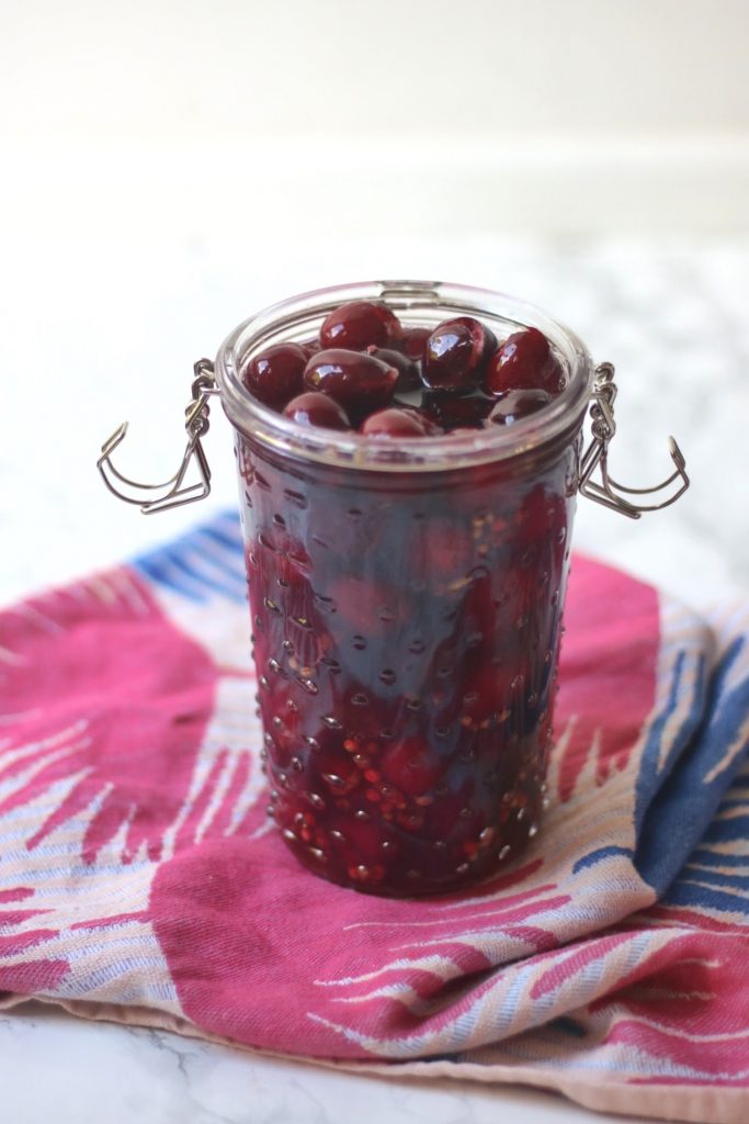 A jar of pickled cherries