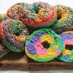 A pile of Rainbow Bagels sliced open
