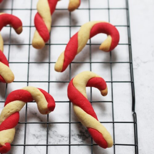Close up vegan candy cane sugar cookies on cooling wrack