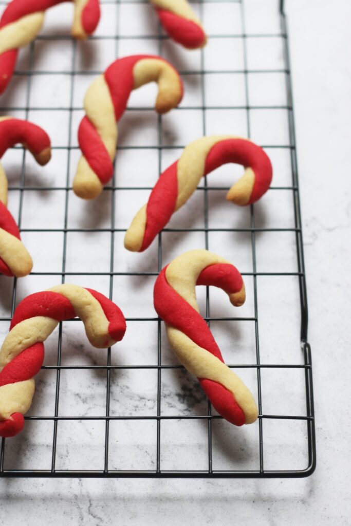 Close up vegan candy cane sugar cookies on cooling wrack