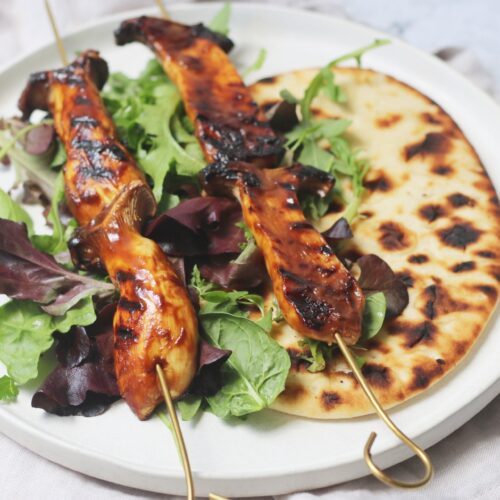 BBQ King Oyster Mushroom Kebabs on a bed of salad and flatbread