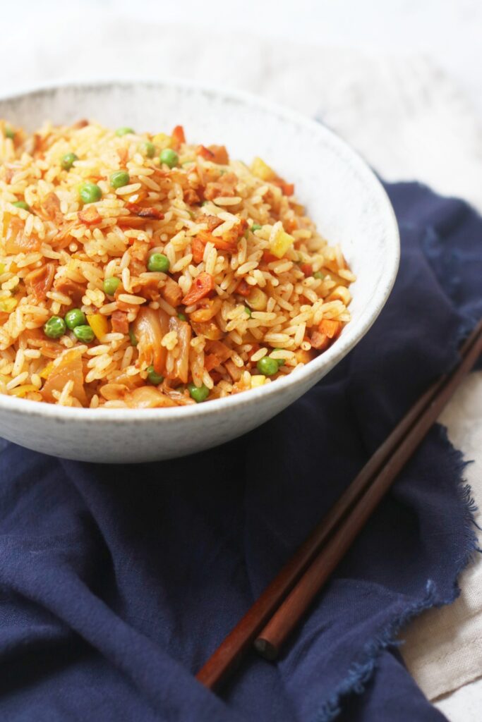 Vegan Kimchi Fried Rice in a bowl with chopsticks
