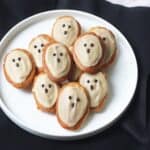 Vegan Madeleines decorated as ghosts using vegan white chocolate and dark chocolate