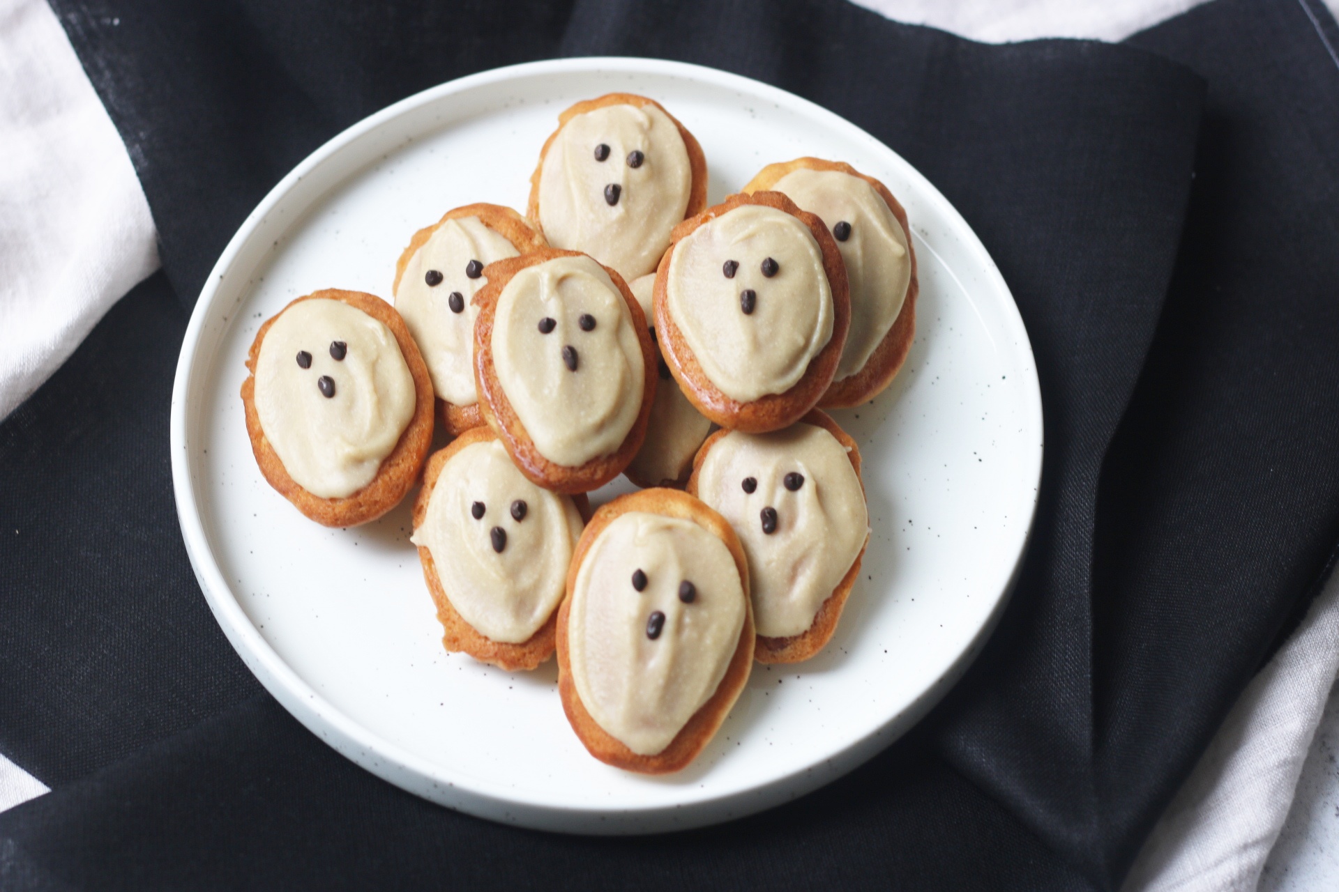 Vegan Madeleines decorated as ghosts using vegan white chocolate and dark chocolate