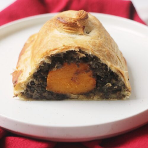 Vegan Butternut Squash Wellington cut in half on a plate