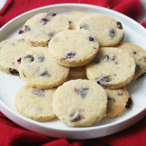 A plate of round Vegan Cranberry and Orange Shortbread