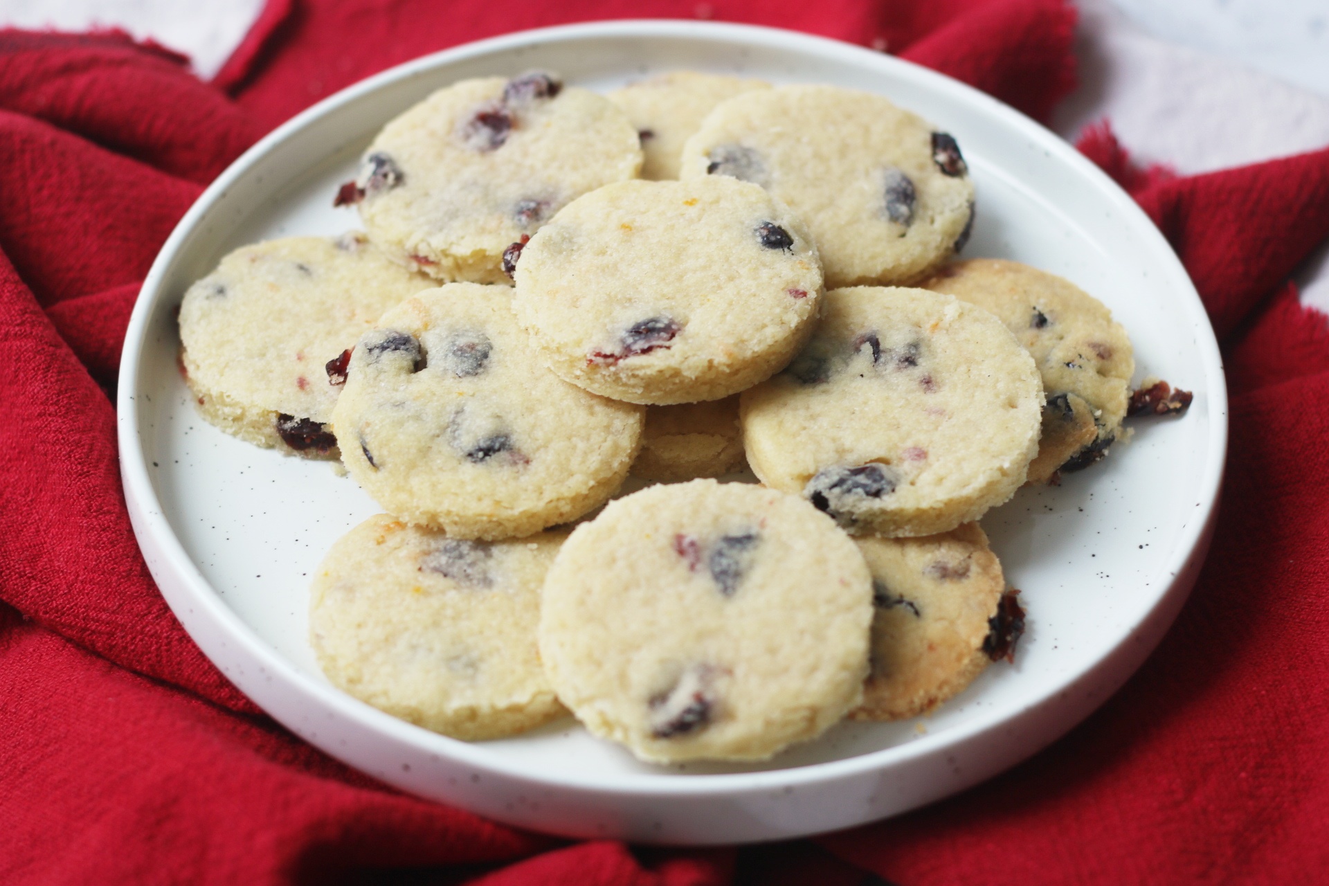 A plate of round Vegan Cranberry and Orange Shortbread