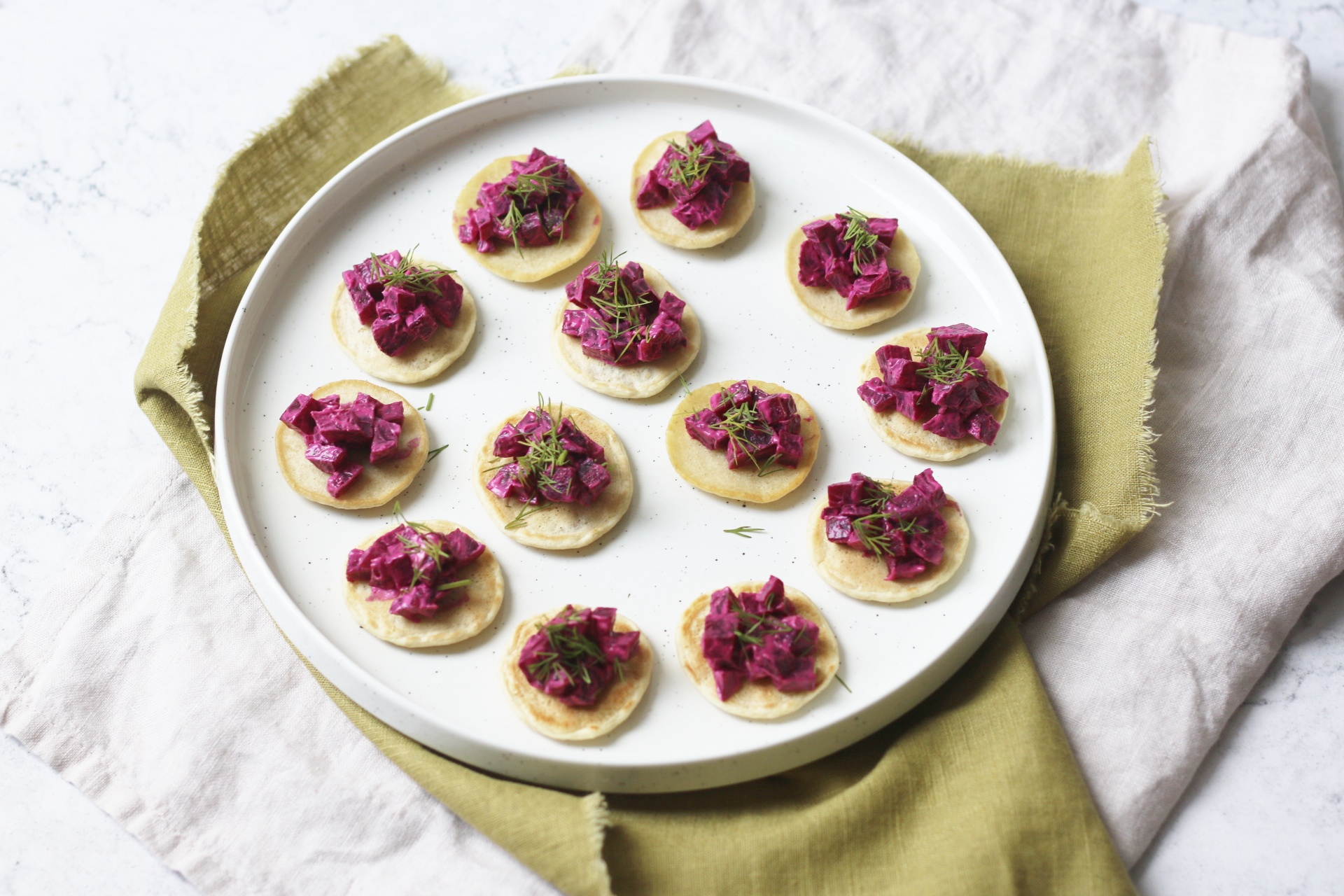 A plate up of Vegan Creme Fraiche, Beetroot and Dill Blinis