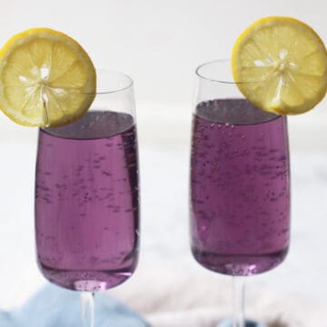 Two Lavender Lemon and Prosecco Cocktails with slices of lemon