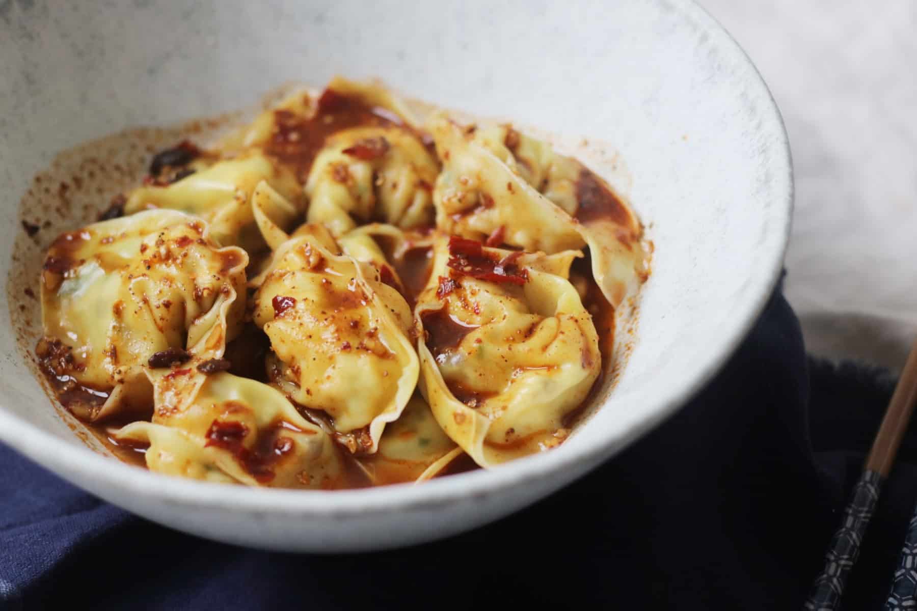 Close up bowl of Vegan Wontons in Chilli Sauce