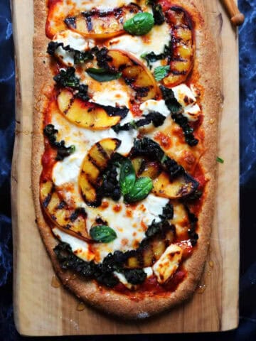 A pizza topped with kale and griddled nectarines