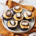 6 Vegan Creme Egg Cupcakes on a white plate