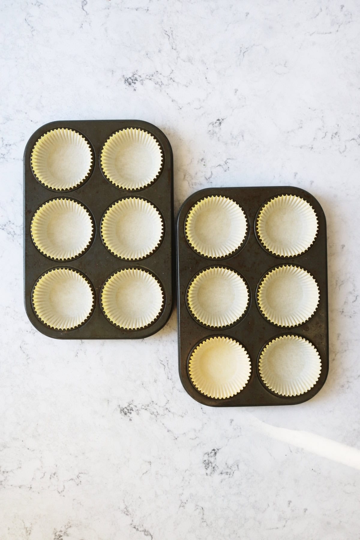 Yellow paper cases in muffin tins