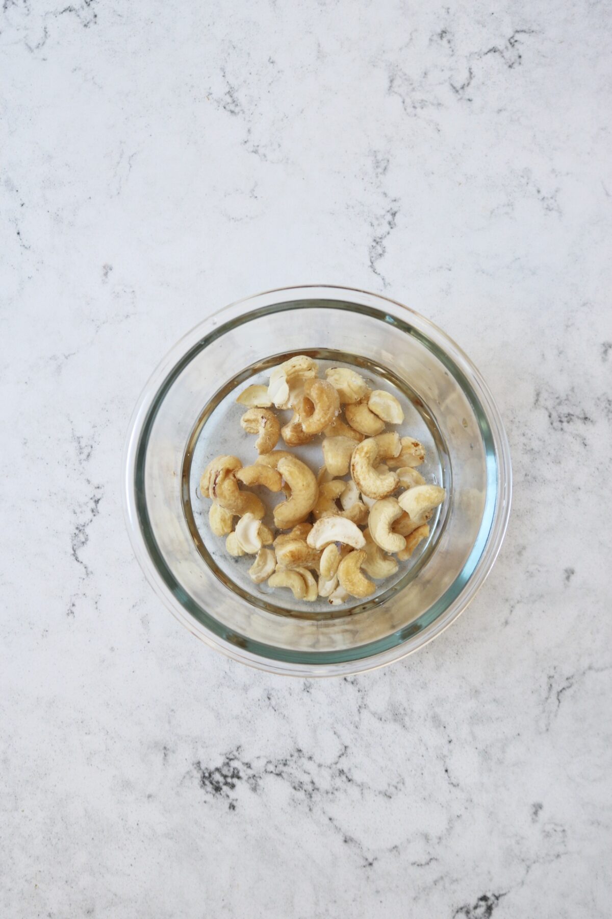 A bowl of cashew nuts soaking in water