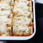 Vegan Spinach Lasagne Rolls in a white and blue enamel oven dish