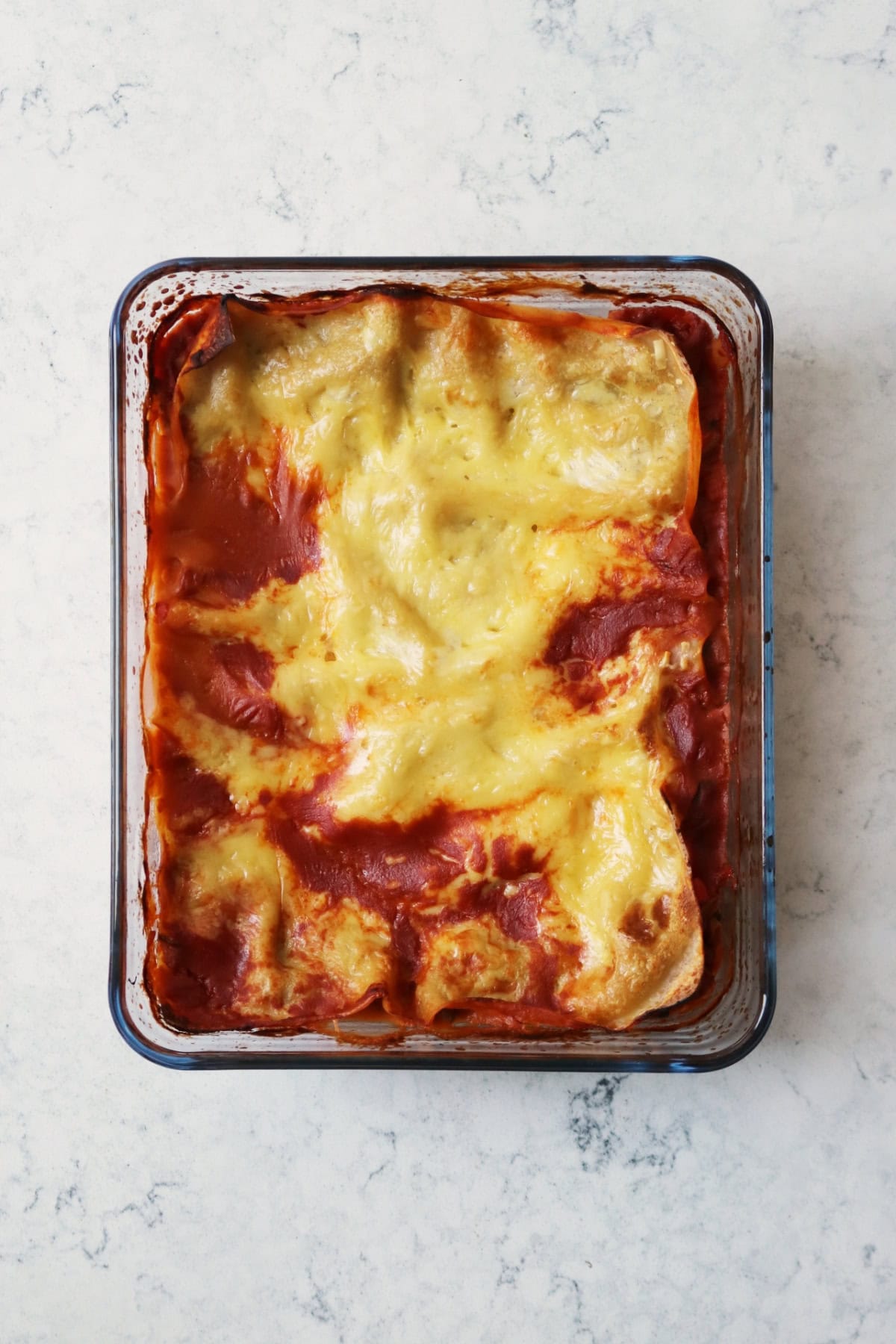 A baked vegan lentil lasagne in a glass oven dish