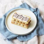 A Vegan Mille-Feuille on a white plate with a pale blue napkin