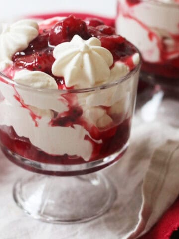 A Plant Based Gooseberry and Strawberry Eton Mess in a glass pudding dish