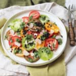 A plate of Tomato Salad with Salsa Verde and Balsamic Pearls
