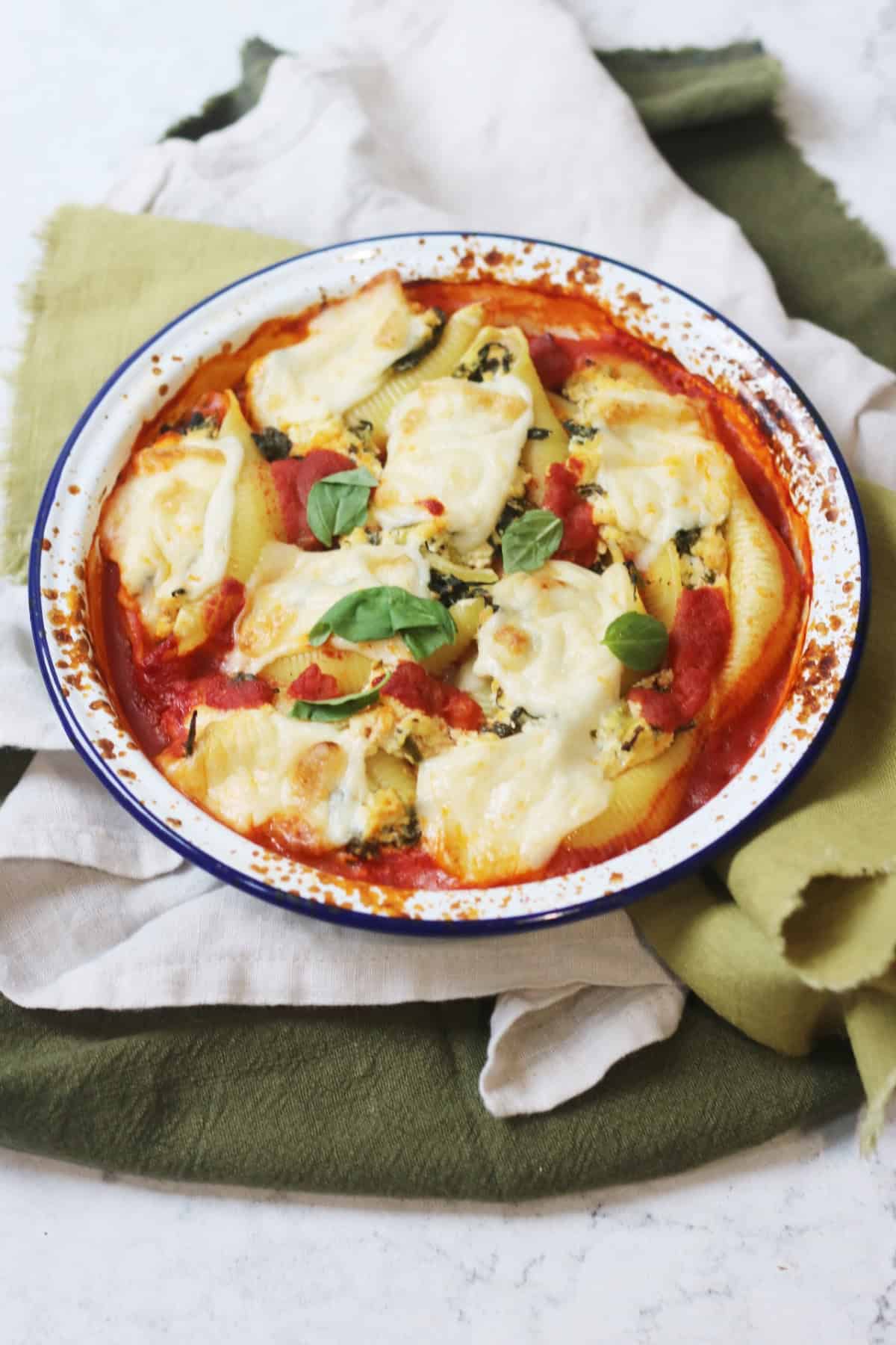 Vegan Spinach and Ricotta Stuffed Pasta Shells in an oven dish resting on green napkins