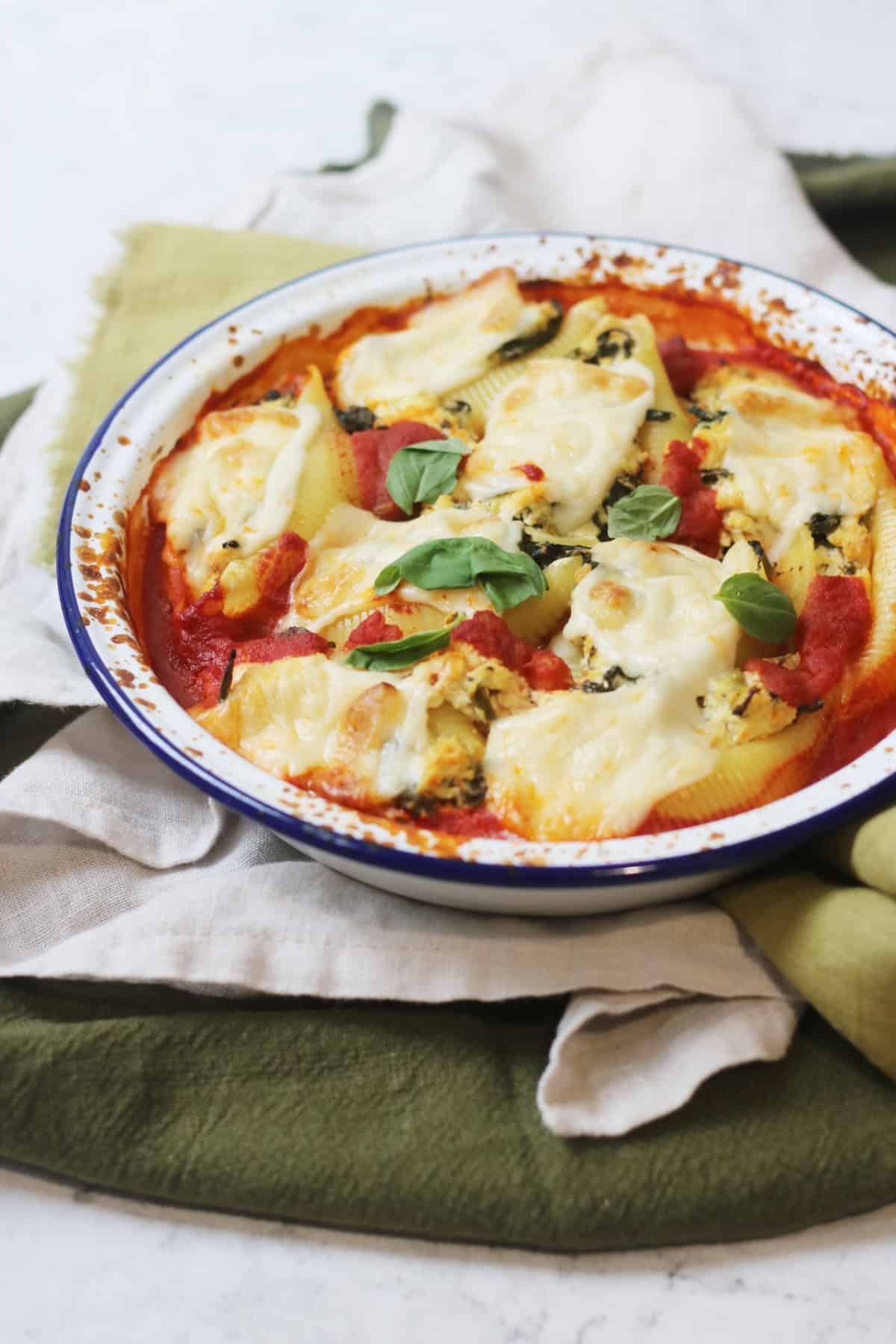 Vegan Spinach and Ricotta Stuffed Pasta Shells in an oven dish resting on green napkins