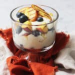 Vegan Grilled Peach and Blueberry Parfait in a glass pudding bowl