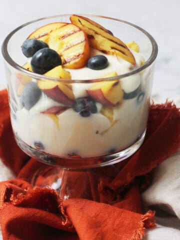 Vegan Grilled Peach and Blueberry Parfait in a glass pudding bowl