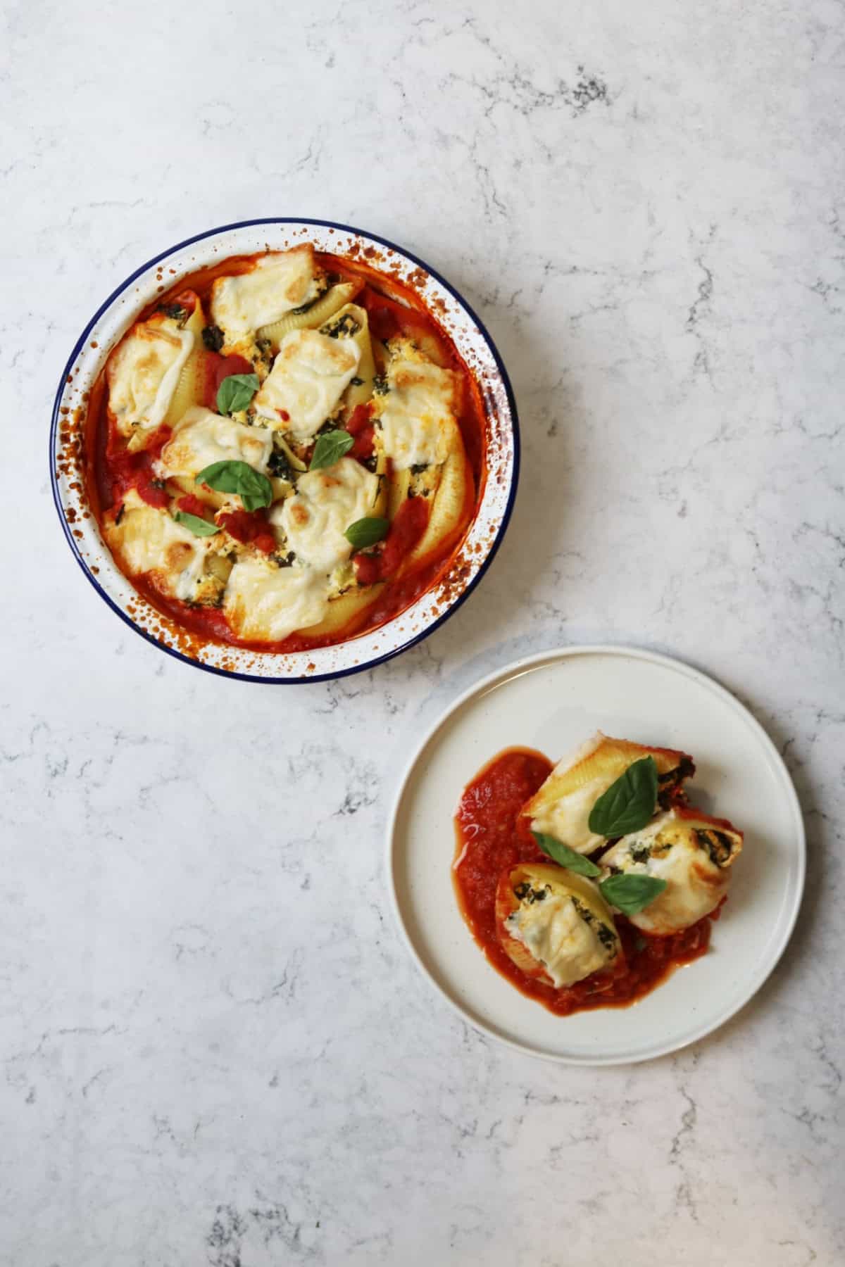 An oven dish of Vegan Spinach and Ricotta Stuffed Pasta Shells and a plate with 3 Vegan Spinach and Ricotta Stuffed Pasta Shells